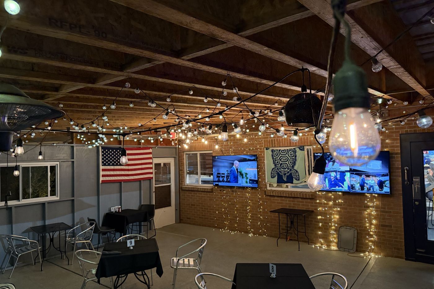The covered patio strung with lights.